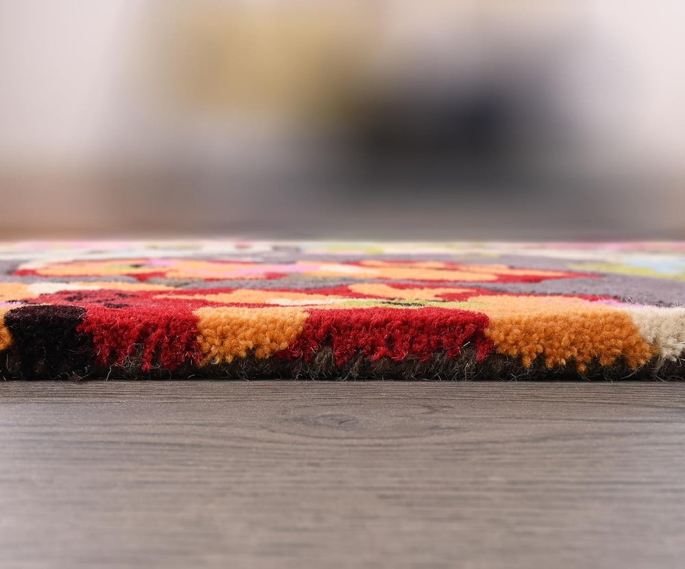 Close-up colorful textured rug with warm tones on wood floor.