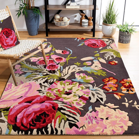 Dark floral rug, wood floor, chair, plants, shelf.