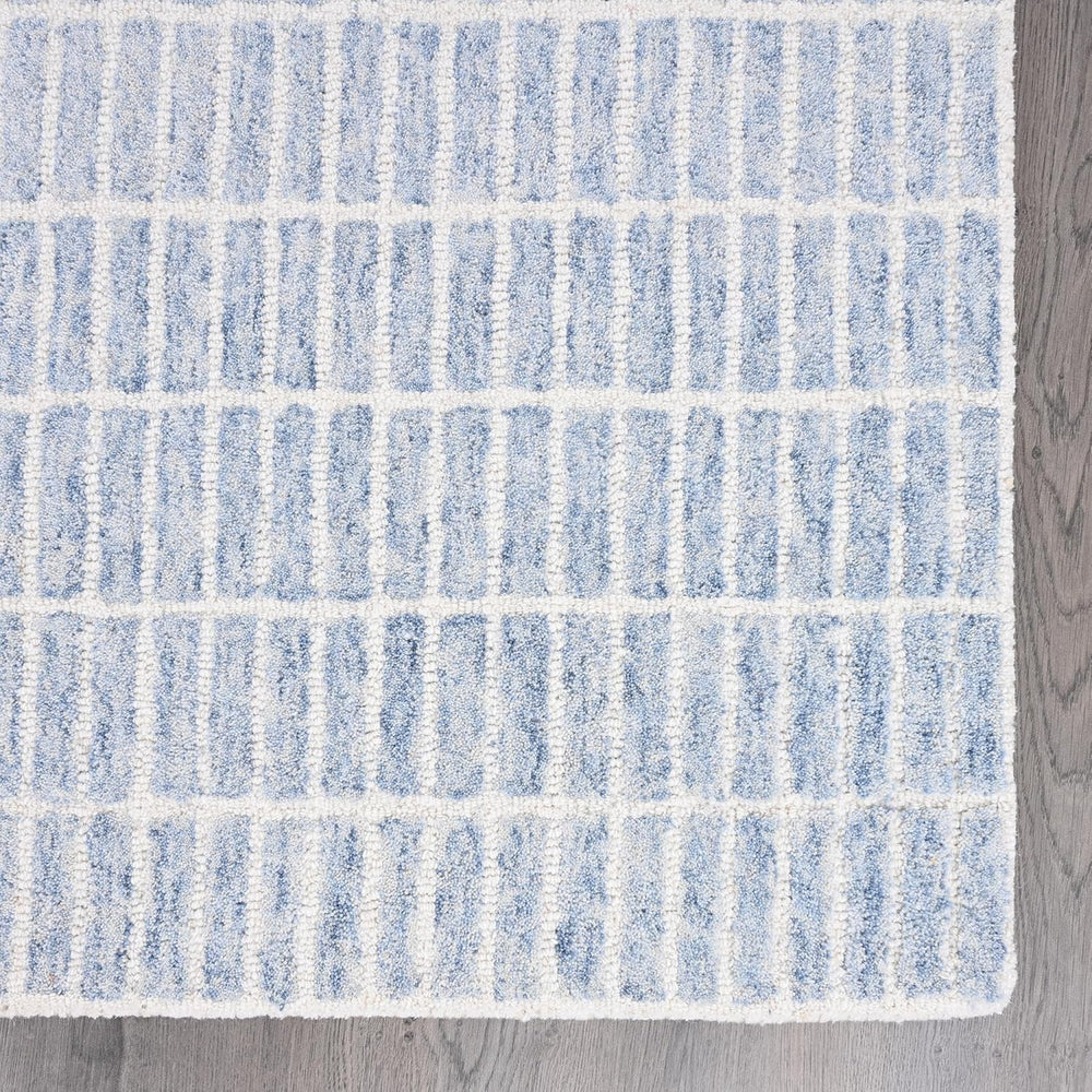 Close-up light blue-white striped wool rug.