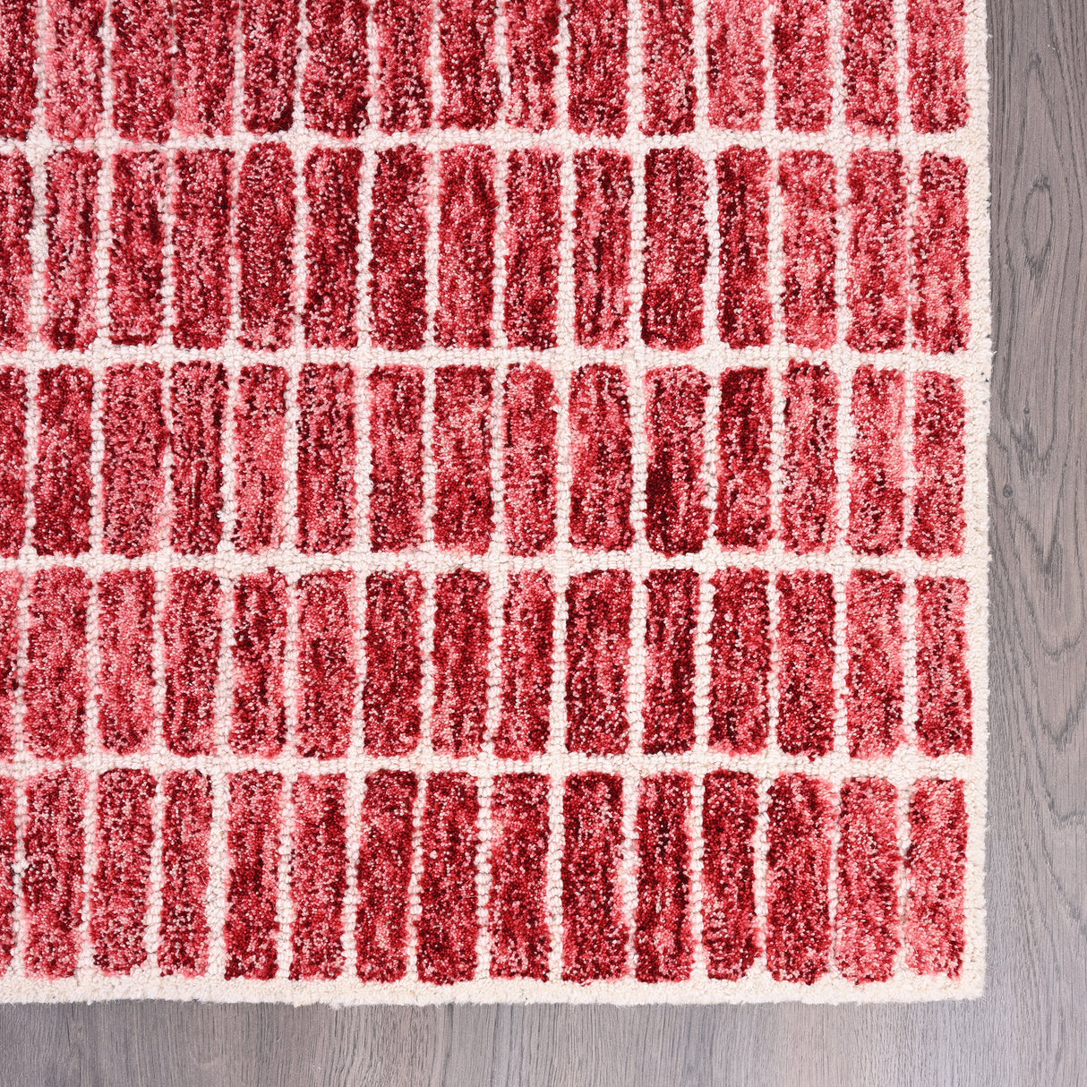 Close-up modern tribal rug with red-white blocks.