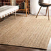 Close-up jute rug, wood floor, bench, chair.